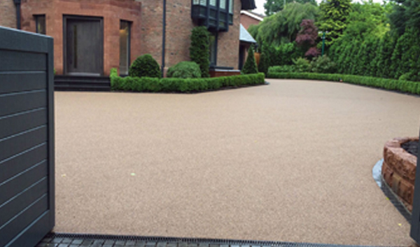 Resin bound driveway with grey gate at a large detached house
